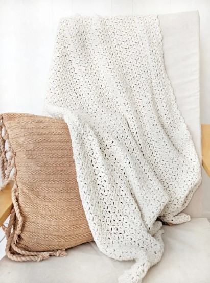 easy one-stitch repeat crochet blanket on chair with cushion