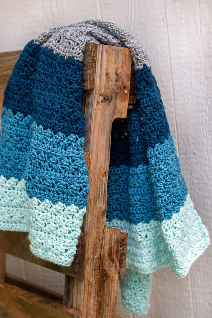 simple stitch easy crochet baby blanket on wooden chair