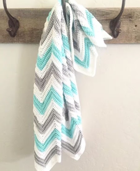 crochet chevron blanket hanging on a hook
